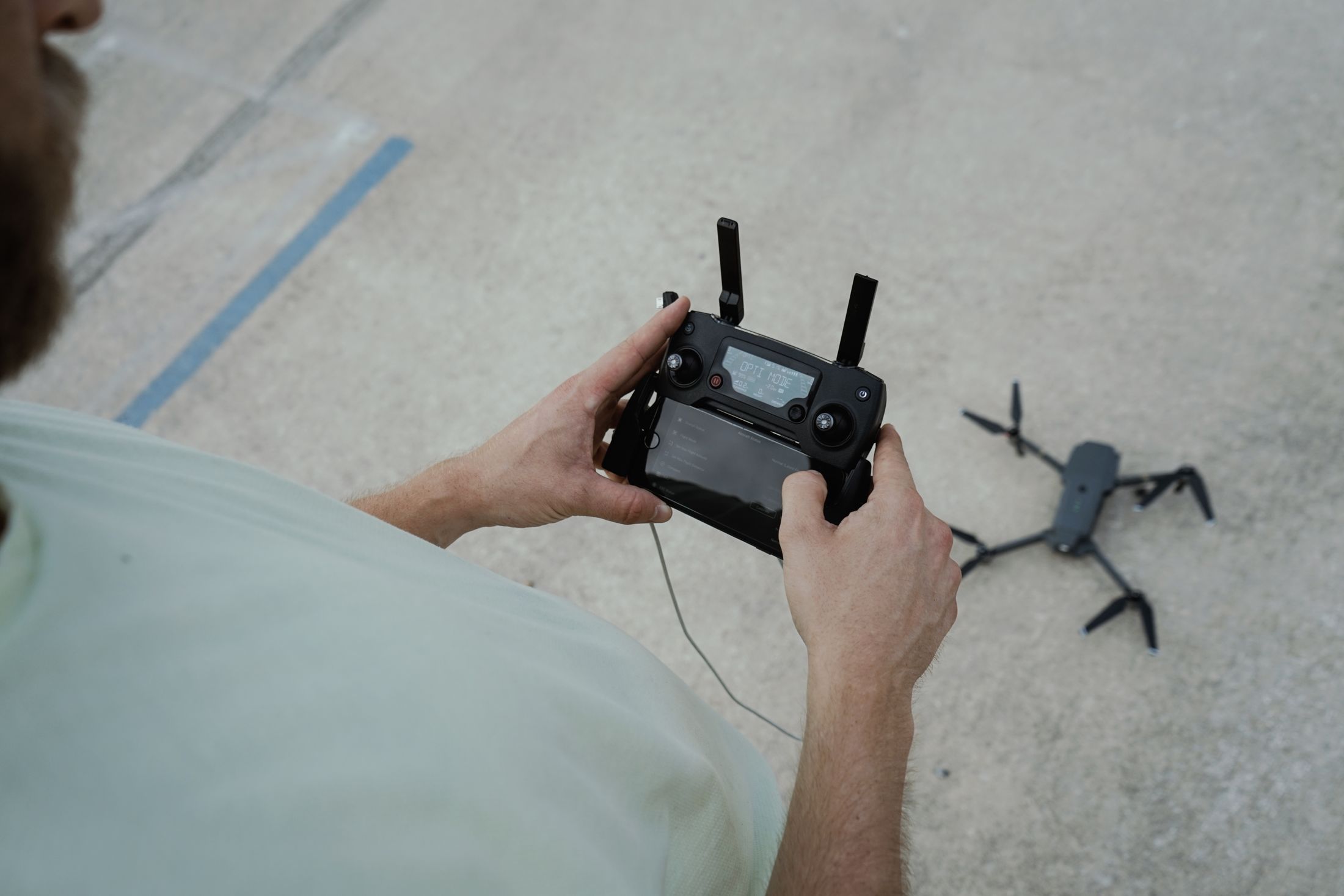 Civilian drone operator using a controller to prepare for flight